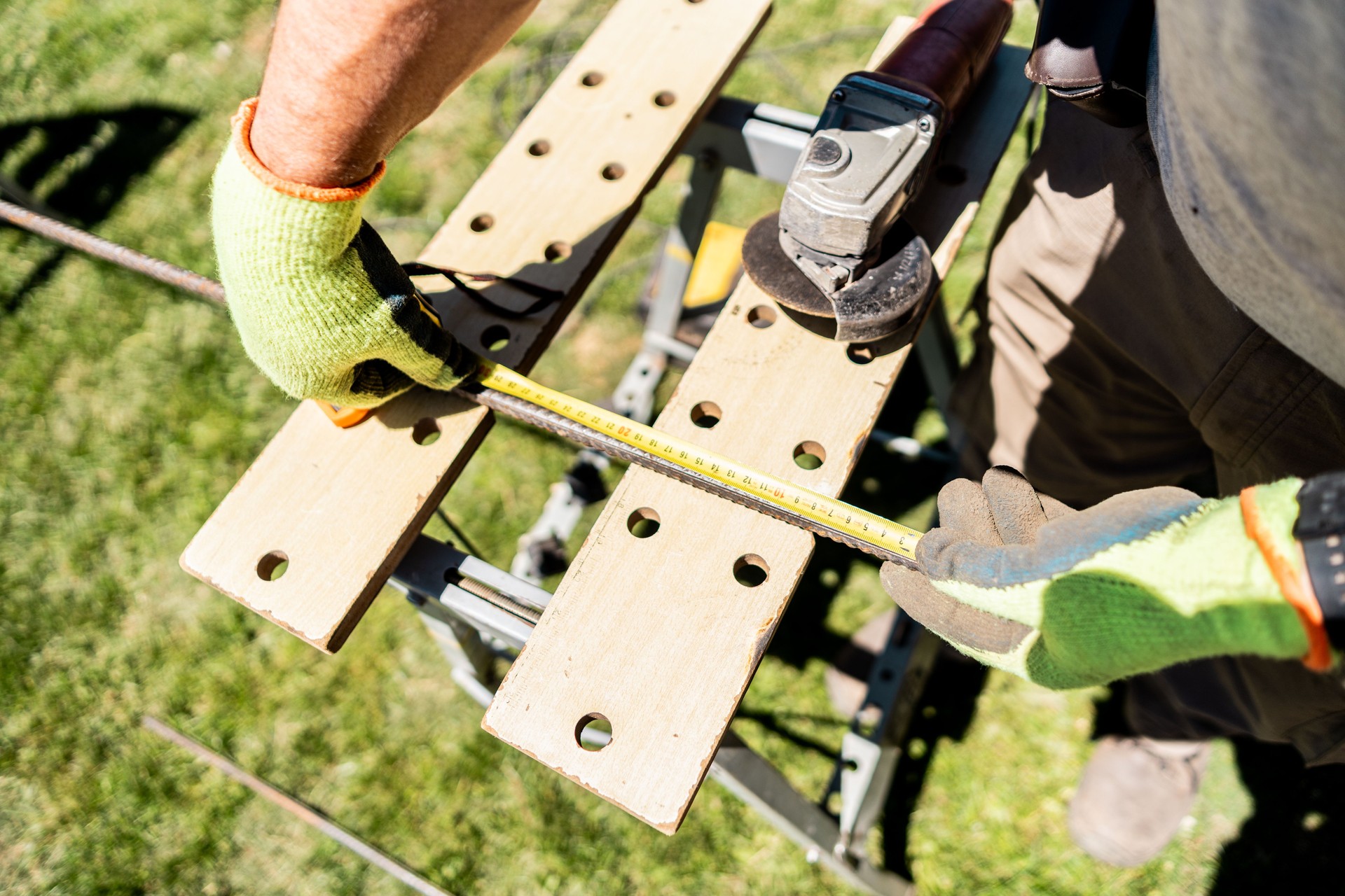 Close-up of a carpenter using the tape measure in a backyard